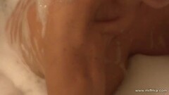 Busty blonde milf takes bubble bath and rubs pussy Thumb